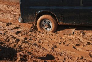 black car stuck on mud